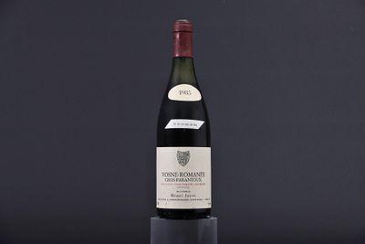 a bottle of wine sitting on top of a black table