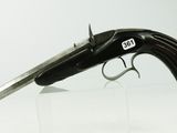 an old gun that is on display on a glass stand