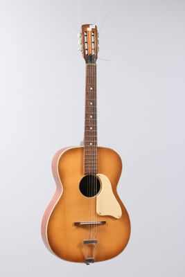 an image of a guitar hanging from a string on a wall