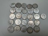 some silver coins are arranged in a square on a table