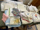 a table with many different types of clothing on it