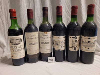 several bottles of wine are lined up on a table