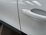 a close up of a door handle on a white car