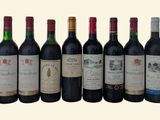 six bottles of red wine are lined up in a row