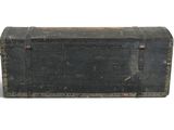 an old black trunk with a wooden top on a white surface