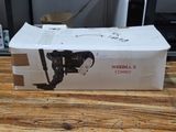 a box with a camera attached to it on a wooden table