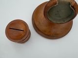 a small wooden container with a lid on a white table