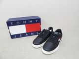 a pair of black and white sneakers sitting next to a box