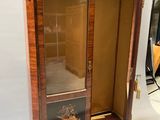 a wooden cabinet with a painting on the door