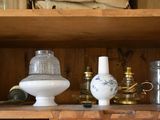 two vases and a lamp on a shelf in a room