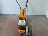 a small lawn mower that is sitting on the floor