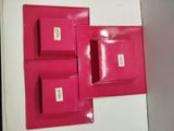 three pink square plates on a white table