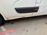 a white van parked in a parking lot next to a building