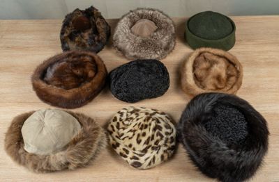 several hats are lined up on top of a wooden table