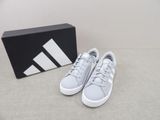 the adidas sneakers are white and grey with a black box in the background