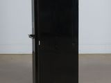 a black refrigerator sitting in the middle of a room