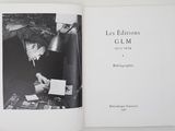 someone is holding a book with a black and white photo of a man sitting at a desk