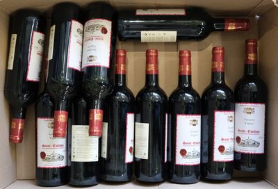 bottles of red wine in a cardboard box on a table