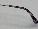 glasses are laying on a white surface with a white background