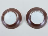 pair of brown and white plates on a white surface