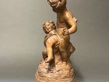 statue of a boy and a girl on a rock