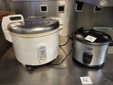 a crock pot sitting next to a crock pot on a counter