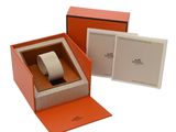 an orange box with a watch inside of it and a card in it