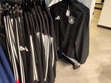 a lot of clothes hanging on a rack in a store