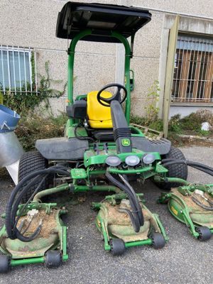 a picture of a lawn mower parked in front of a building