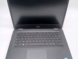 a dell laptop computer sitting on a white surface