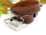 a brown leather belt with a silver buckle on it