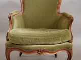 an image of a chair with a green upholstered cushion on it