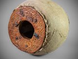 a close up of a clay object with a hole in it