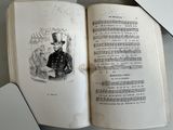 un livre ouvert sur lequel est dessiné un homme coiffé d'un haut-de-forme