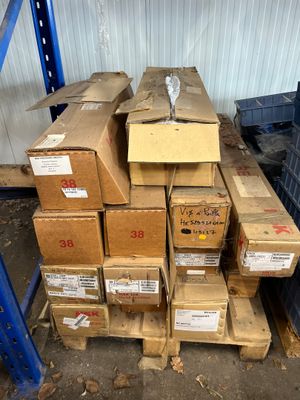 many boxes stacked on top of each other in a warehouse