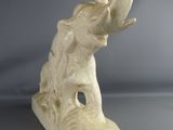 statue of an elephant with a ring in its trunk
