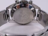 a close up of a watch on a white surface