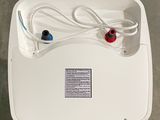 a white box with wires attached to it on the floor