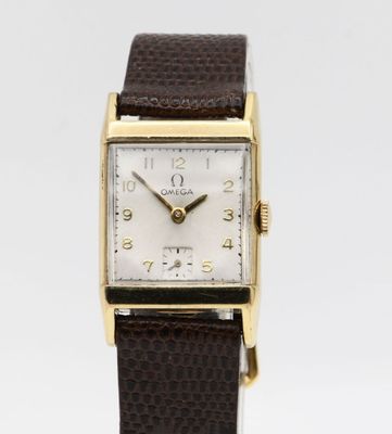 an image of a gold plated wrist watch with a brown leather strap