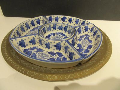 a blue and white plate sitting on top of a white table