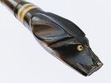 an image of a wooden stick with a snake head on it