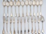 a lot of silver spoons and forks on the table