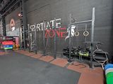 a gym room with a lot of equipment in it