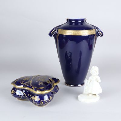 a blue vase and a small white figurine next to it