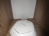 un petit appareil blanc posé sur une étagère dans une pièce