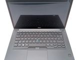 a laptop that is open on a white surface