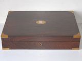 a small wooden box with a lid on a white surface