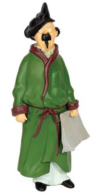 figurine of a man in a green robe with a black hat and a paper