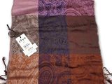 an image of a multicolored scarf with a tag on it