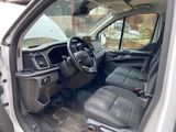 the interior of a white van with black seats and dashboard